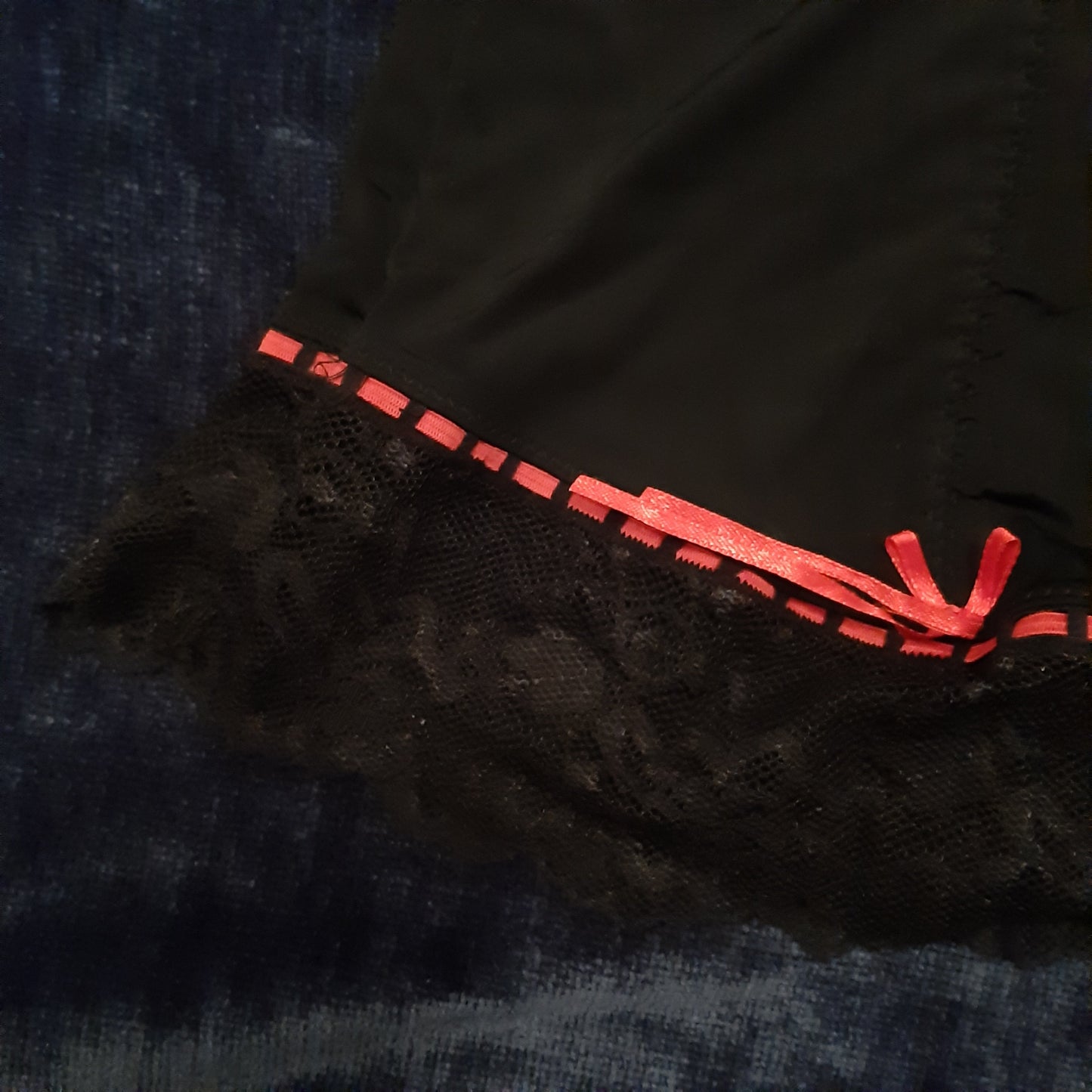 Lacy black slip with red accents