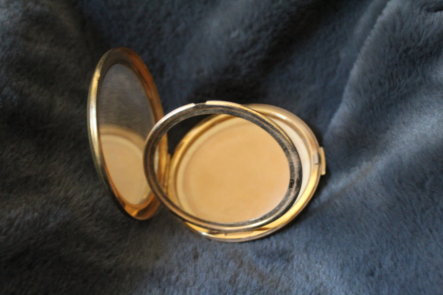 Round, gold Stratton compact