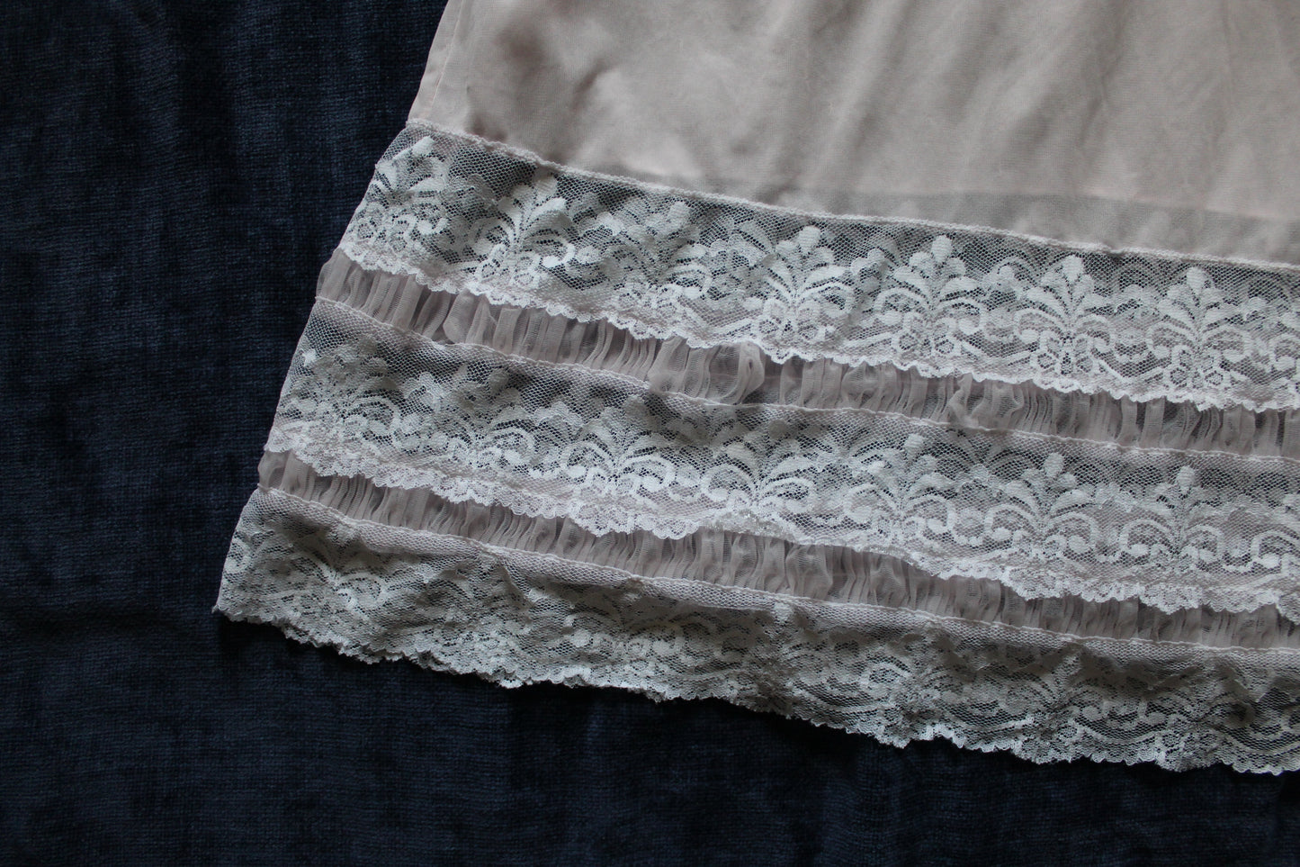 Delicate pastel peach slip with white lace