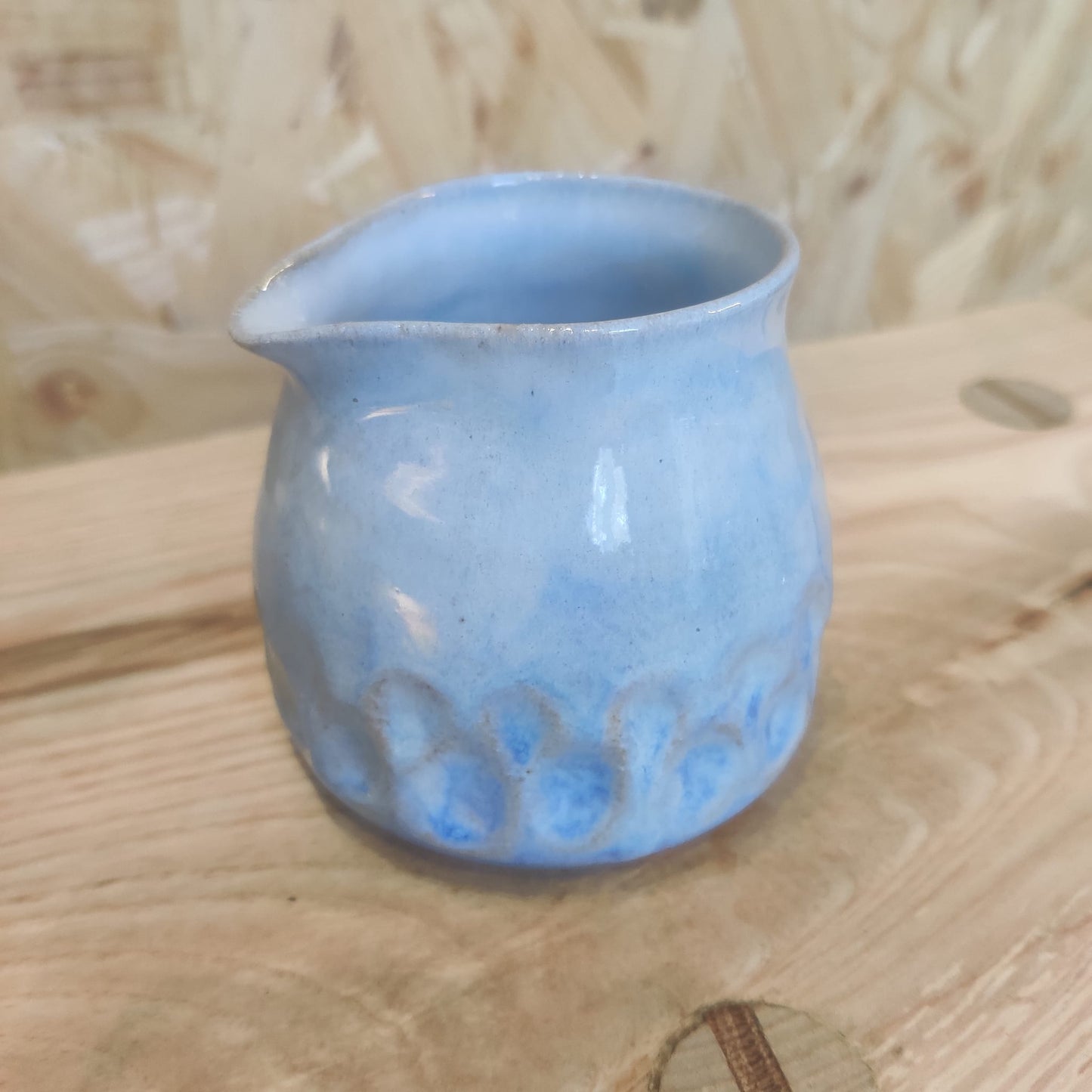 Blue milk jug with grooves