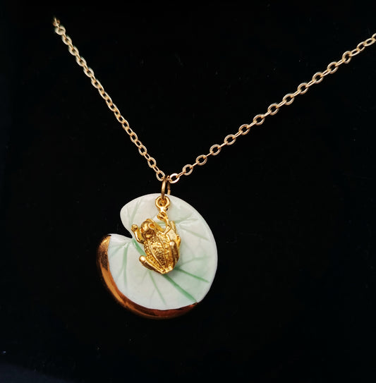 Necklace with a frog charm on a lilypad